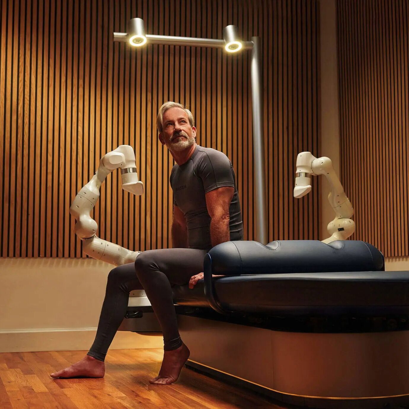 A futuristic robotic massage bed adapting to a guest’s muscle tension in real-time.